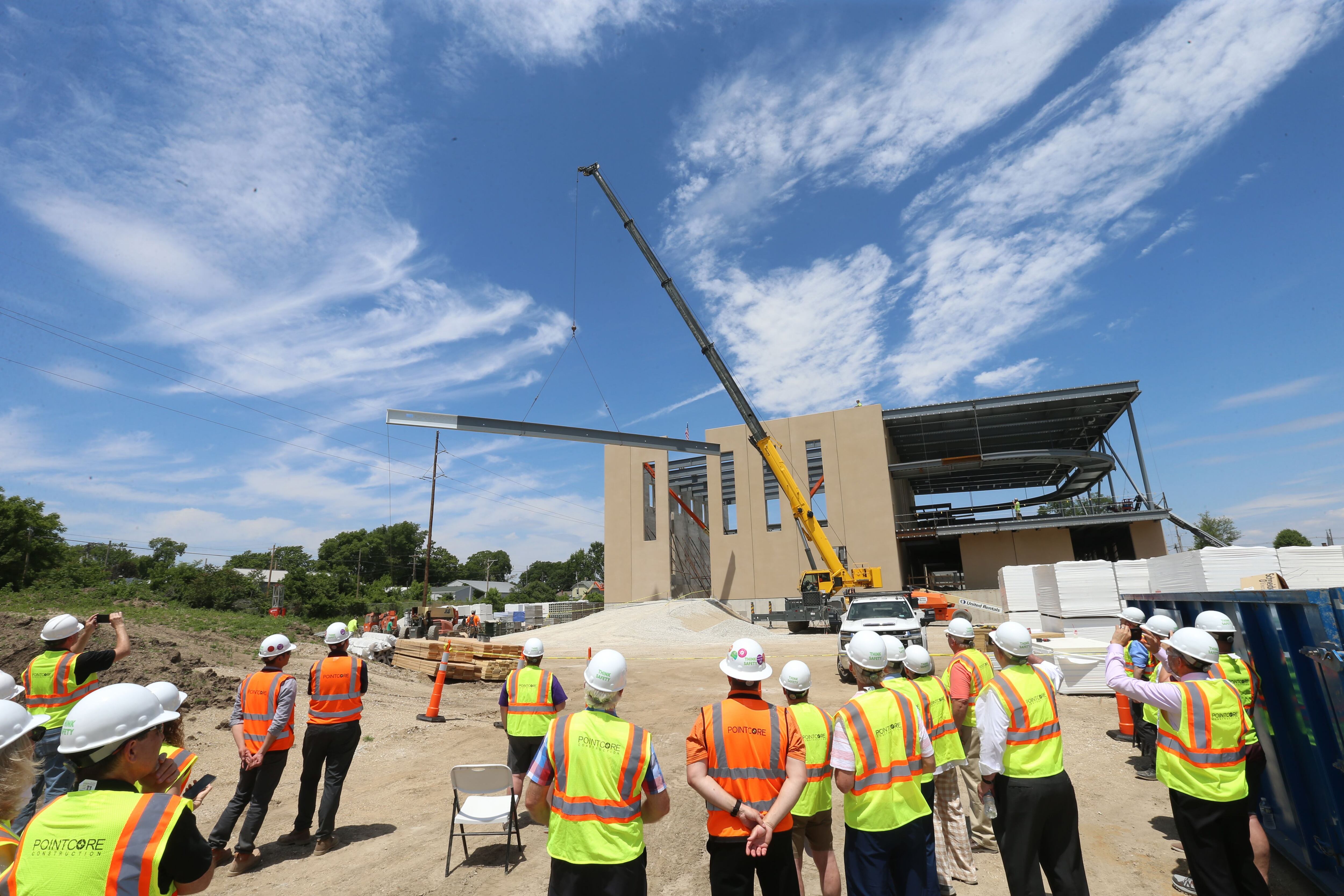 A crane hoists a 92-foot beam Tuesday, May 30, 2023, during a steel signing celebration at the new YMCA building site in Ottawa.