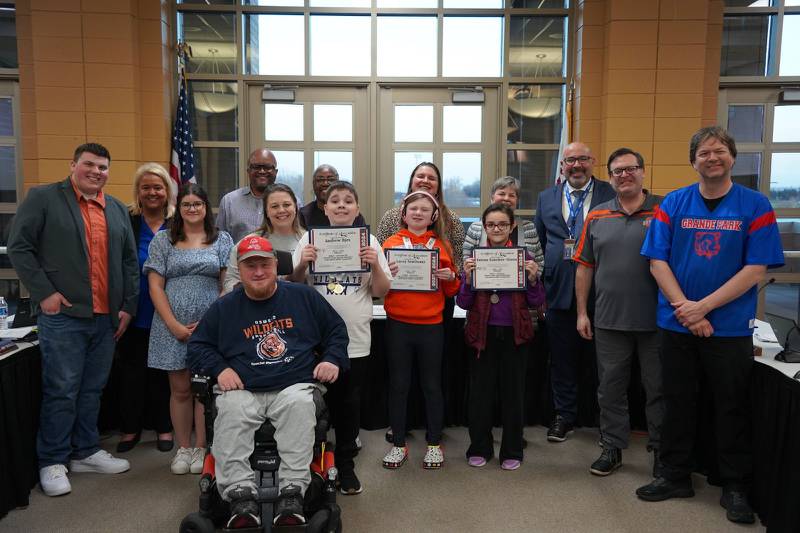 Members of the Oswego SD308 School Board applaud individual gold and silver Special Olympics athletes Andrew Bjes, Lacey Sawitoski and Emma Sanchez-Giron.