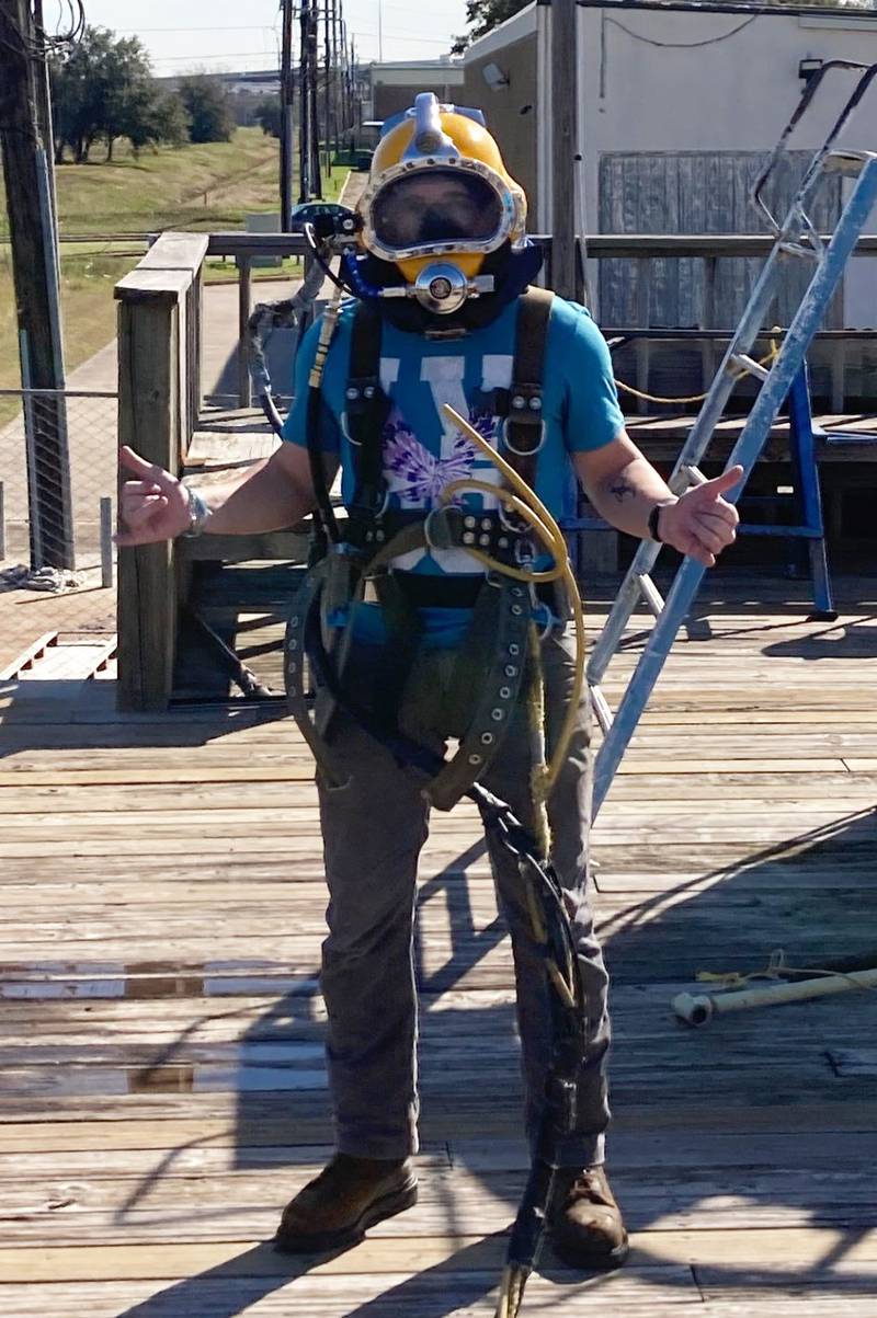 Illinois Valley Community College graduate Caleb Savitch, of Spring Valley, suits up in diving gear to show family and friends back home. He’s been diving almost daily since he began training, practicing drills and tasks with his dive team.