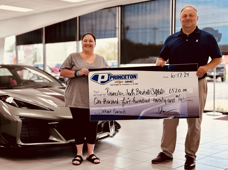 Carly Lucas and Shawn Harden of Princeton Chevrolet presented the Princeton Youth Baseball and Softball League with a check for $1,520 for its recent cookout. PYBSL also held its own cookouts at Zearing Park.
