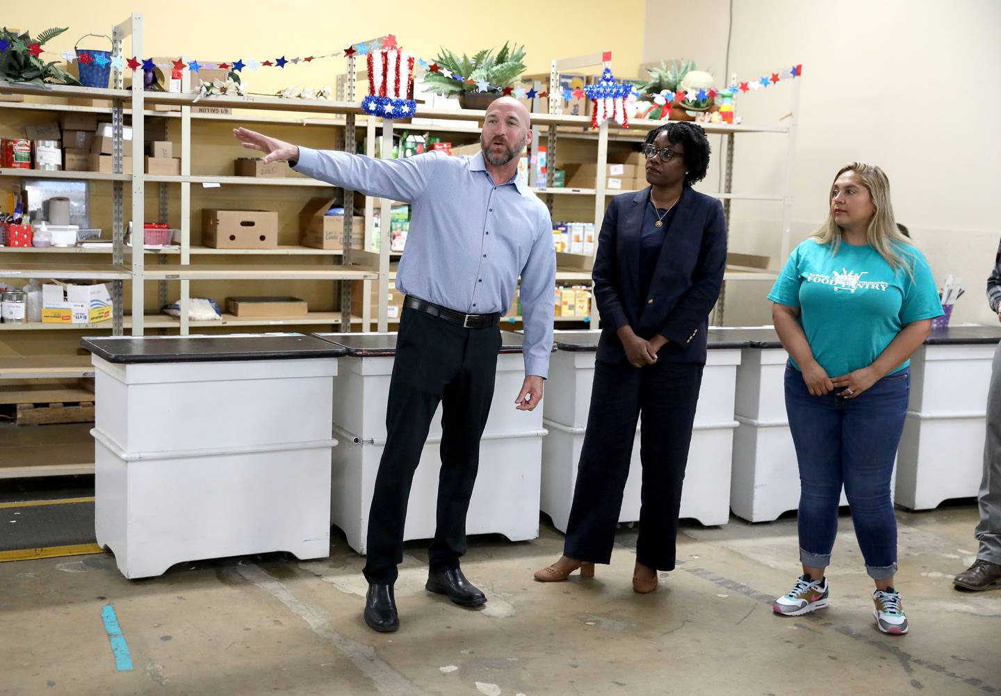 Alex Hurd (far left), executive director of the Kendall County Food Pantry, and Assistant Director Dulce Vargas (far right) give a tour of the Yorkville facility to U.S. Rep. Lauren Underwood on Monday, July 1, 2024. Congressman Underwood was there to present $763,500 for the pantry to rehabilitate the the facility including resurfacing the flooring, installing emergency pathway lighting and handicap entry doors.