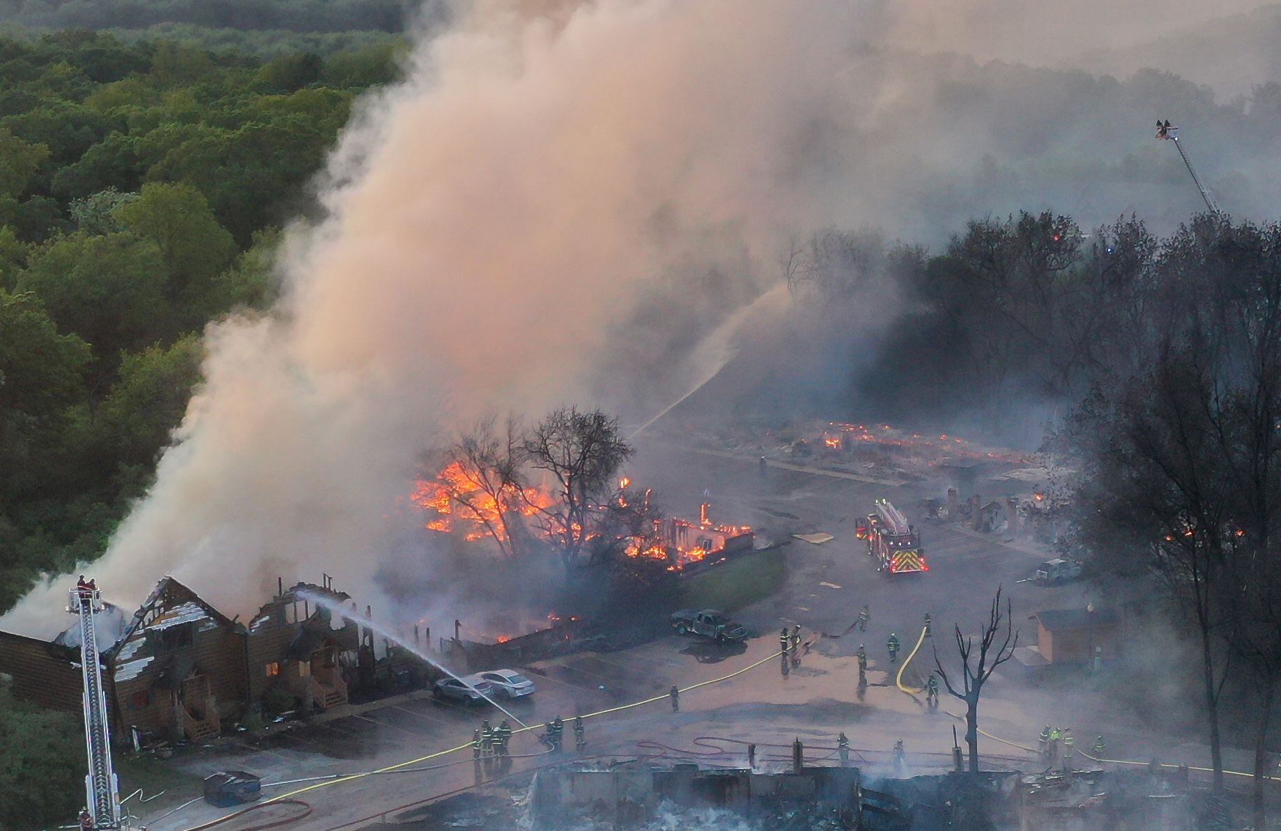 Firefighters fight a five-alarm fire that burned cabins at the Grand Bear Resort on Monday, May 30, 2022 in Utica.