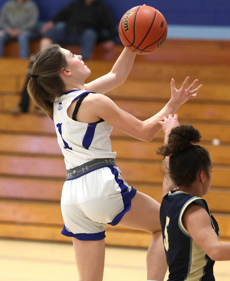 Hinckley-Big Rock’s Payton Murphy shoots a layup over Harvest Christian’s Daphne Brown Monday, Jan. 8, 2023, during their game at Hinckley-Big Rock High School.