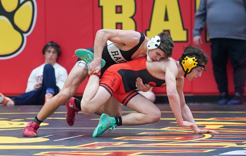 Bolingbrook’s Tommy McDermott grabs the leg of Washington’s Cruise Brolley In a 157-pound third place match during The Clint Arlis Invitational Wrestling meet at Batavia High School in Batavia on Saturday, Jan 13, 2024.