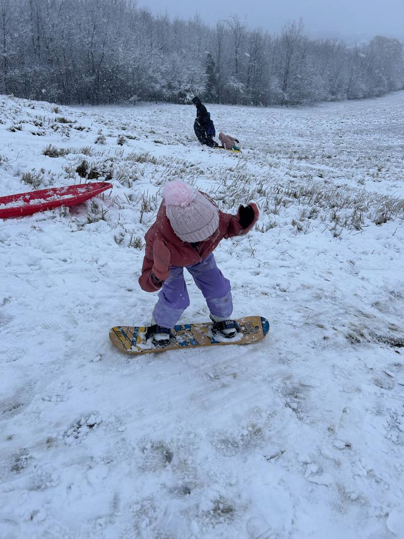 Olivia, 6, of Lake in the Hills, enjoys the snow snowboarding on Tuesday, Jan. 9. 2024, in Algonquin.