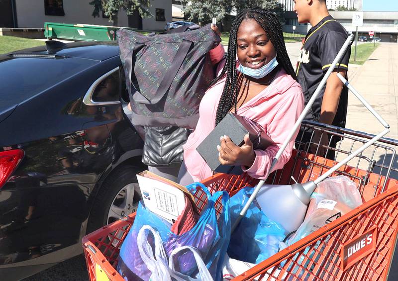 Northern Illinois University junior Tiara Smith, from Chicago, unloads her car Thursday, Aug. 18, 2022, as she moves into New Residence Hall at NIU. Thursday was one of four move-in days for students attending the upcoming school year.