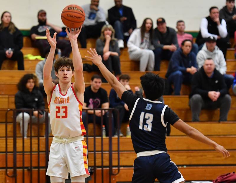 Batavia's Jax Abalos (23) shoots for three points during a Jack Tosh Classic game against Downers Grove South on Dec. 26, 2023 at York High School in Elmhurst.