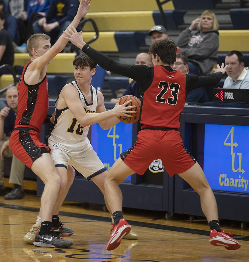 Polo’s Carter Merdian looks to pass while being defended by Fulton Monday, Feb. 12, 2024 at Polo High School.