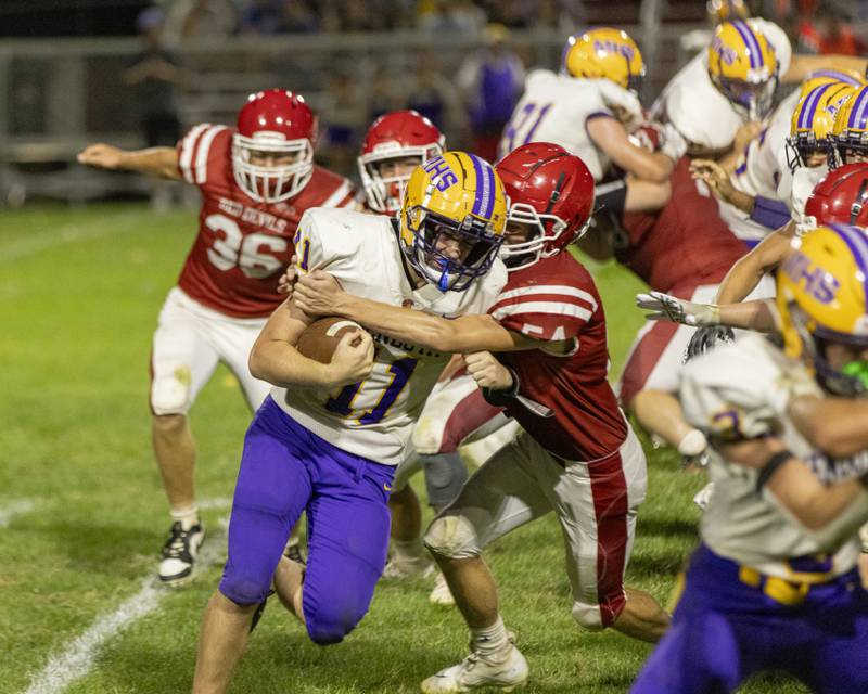 Mendota quarterback Aiden Tillman tries to get back to the line of scrimmage during the game against Hall High School at Richard Nesti Stadium on September 13, 2024.