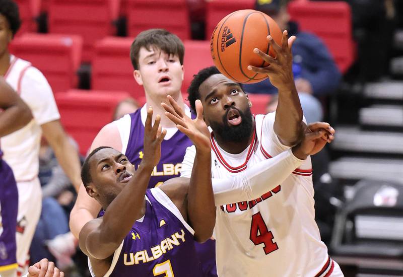 Northern Illinois Huskies forward Oluwasegun Durosinmi and Albany Great Danes guard Da'kquan Davis go after a rebound during their game Tuesday, Dec. 20, 2022, in the Convocation Center at NIU in DeKalb.