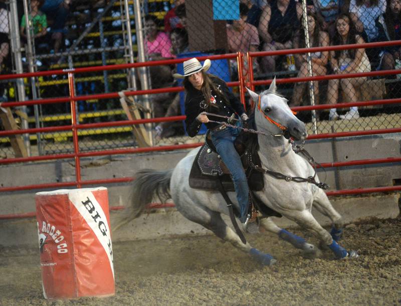 Josey Weber of Chana clears the first barrel with her horse in the barrel racing event at the Big Hat Rodeo at the Ogle County Fair on Friday, Aug. 4, 2023.