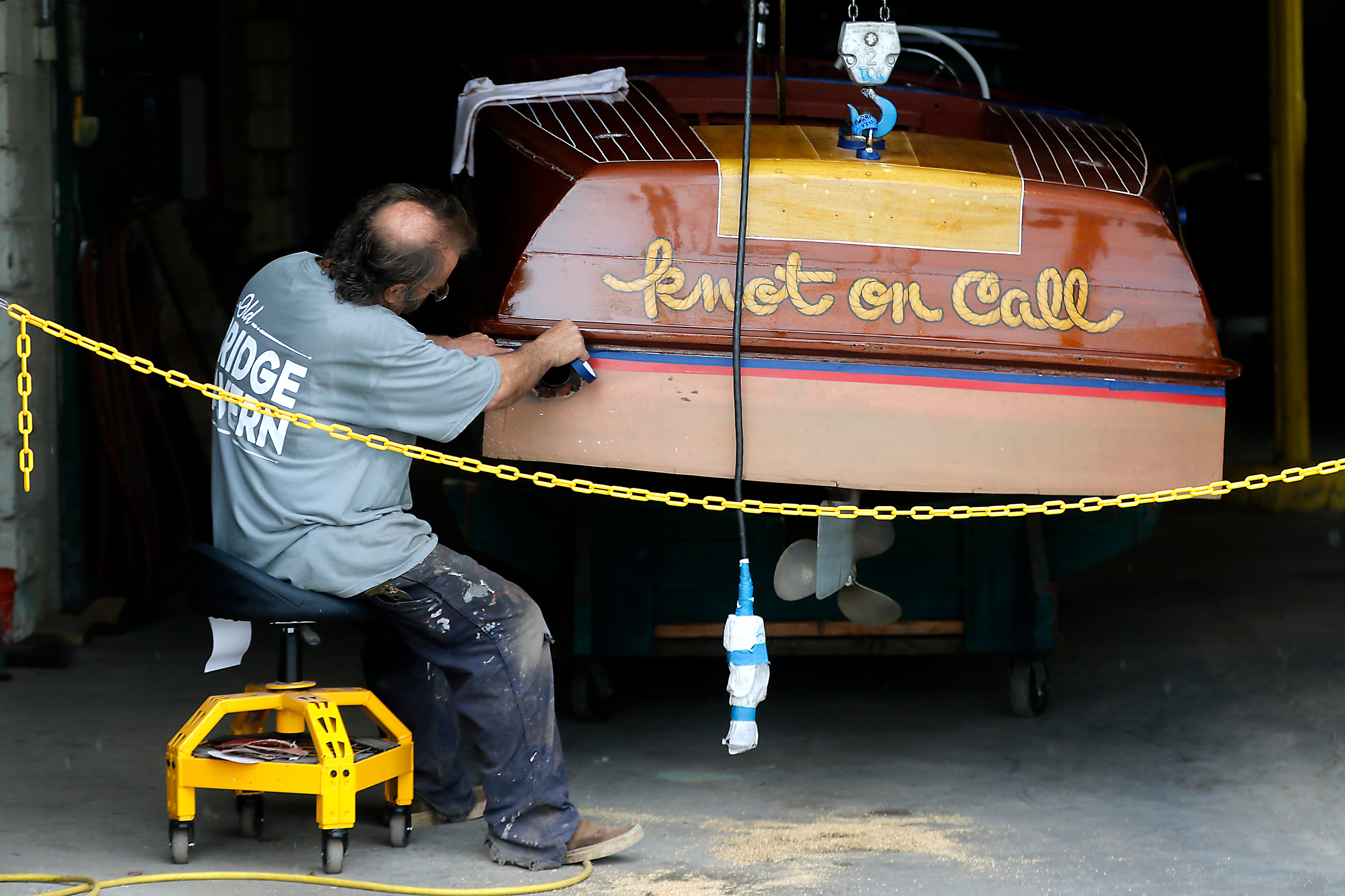 A wooden boat is worked on at Fox River Valley Boat Company along a recently opened section of the McHenry Riverwalk on Tuesday, July 24, 2024. With the opening of this section between Pearl Street and West Elm Street you can now walk along the Fox River and Boone Creek all the way from Green Street to Webers Park.