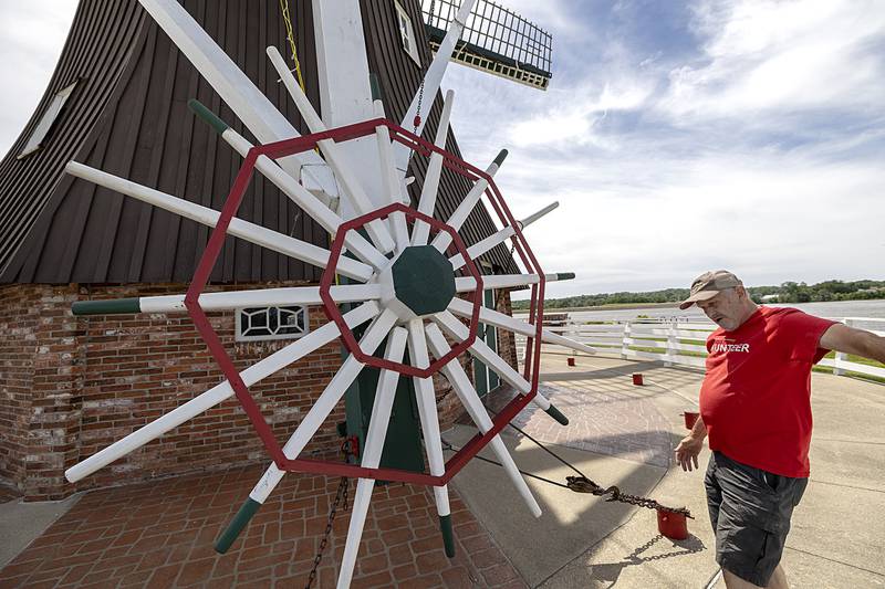 Russell points out the capstan on the Fulton windmill Friday, June 7, 2024. The wheel is used to turn the blades into the best direction for the wind.