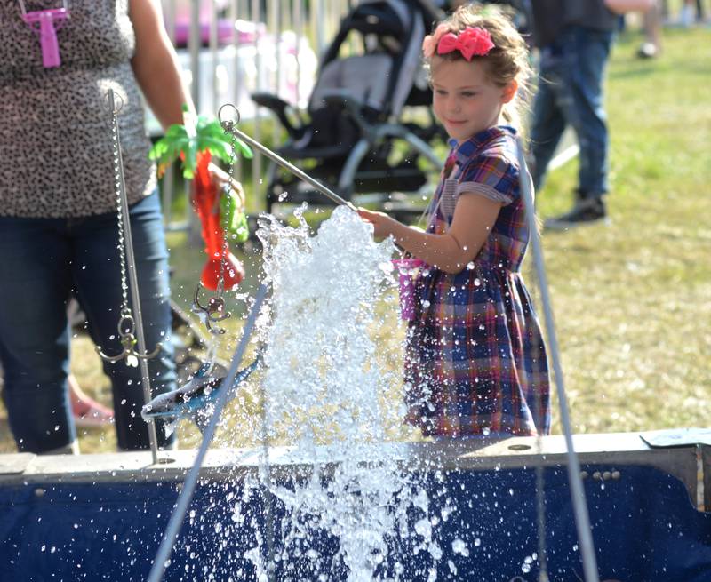 Sadie Pannkuk, 5, of Shannon, hooks a plastic shark in the midway at the Ogle County Fair on Friday, Aug. 4, 2023.