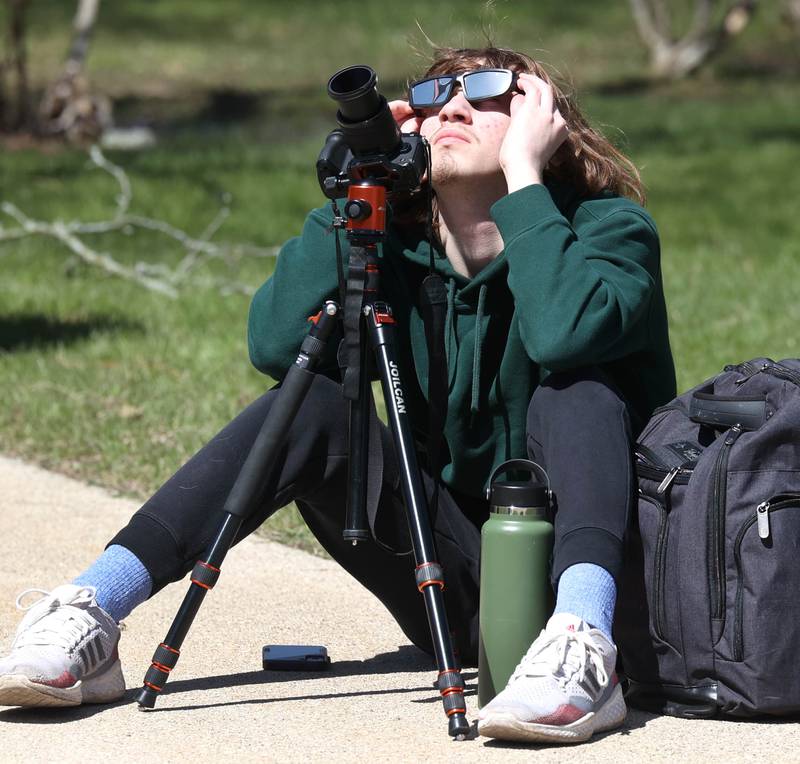 Michael Roberts, a freshman at Northern Illinois University from Huntley, gets ready to photograph the eclipse Monday, April 8, 2024, at the NIU Solar Eclipse Viewing Party behind Davis Hall in DeKalb. Attendees were treated to perfect weather to watch the rare celestial event.