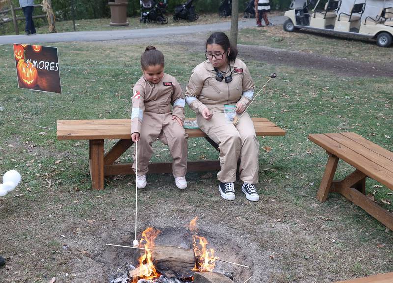 Alex, left, and Layla make S’mores at the Hayride of Horrors on Monday, Oct. 14, 2024 at Dellwood Park in Lockport.