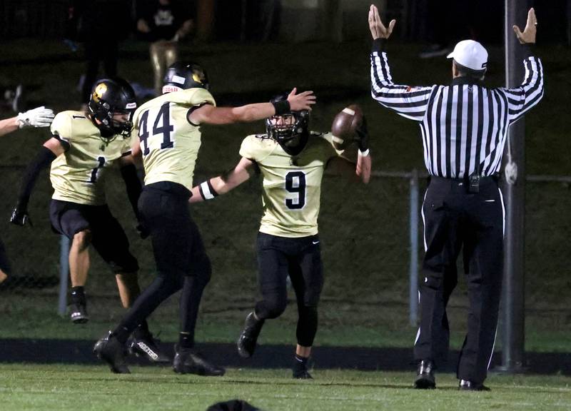 Sycamore players celebrate in the end zone after Caden O’Donnell’s pick-6 during their game against Morris Friday, Oct. 18, 2024, at Sycamore High School.