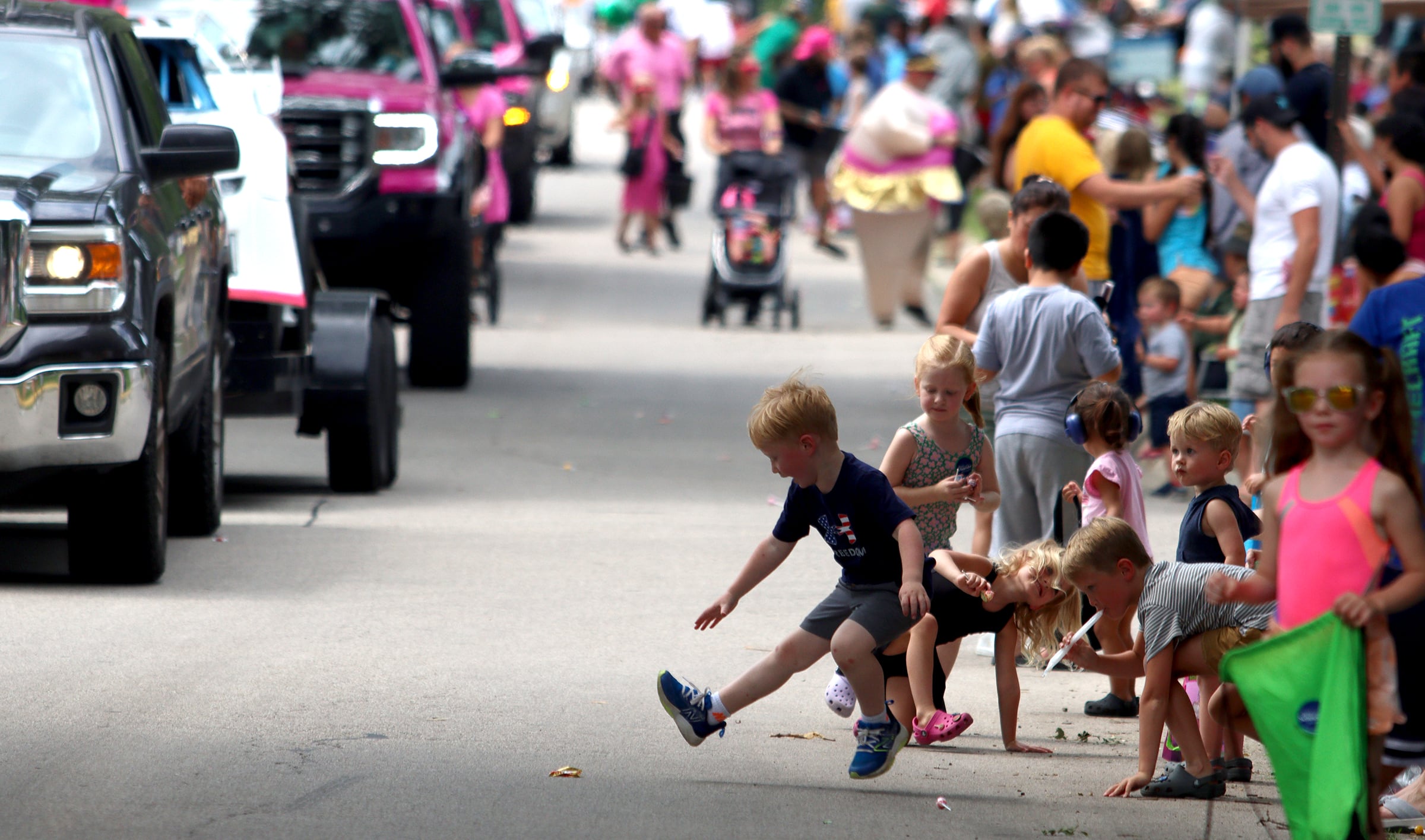 Children gather candy as part of the Fiesta Days parade along Main Street in McHenry Sunday.