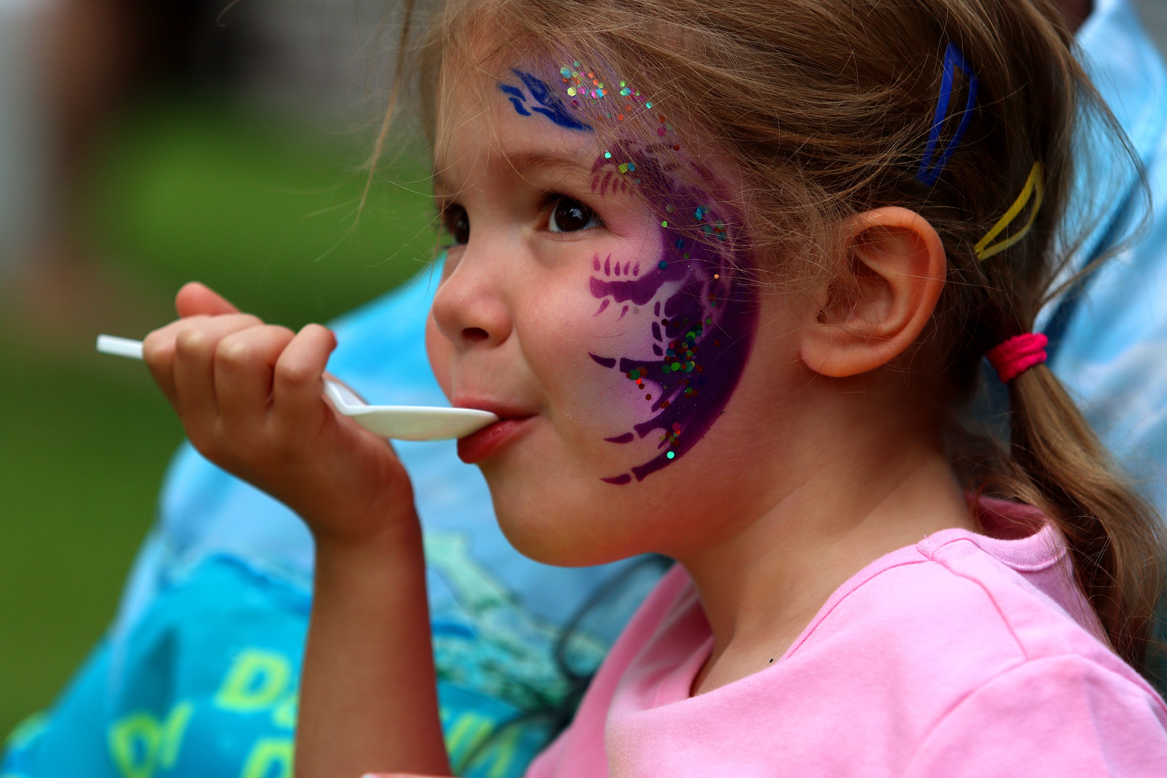 Ellie Santiago, 5, of Crystal Lake enjoys shaved ice with her grandpa JJ Ontiveros as part of The Dole Farmers Market in Crystal Lake Sunday.