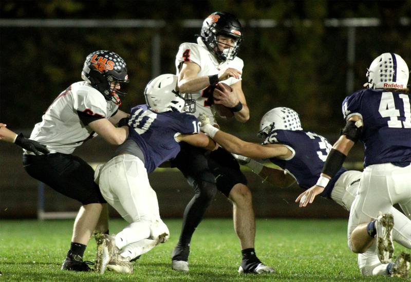 Libertyville’s Blaise LaVista runs the ball in first-round Class 6A playoff  football action at Cary Friday.