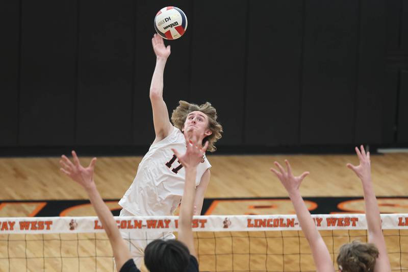 Lincoln-Way West’s Connor Jaral goes for the middle kill against Plainfield North on Monday, March 18, 2024 in New Lenox.