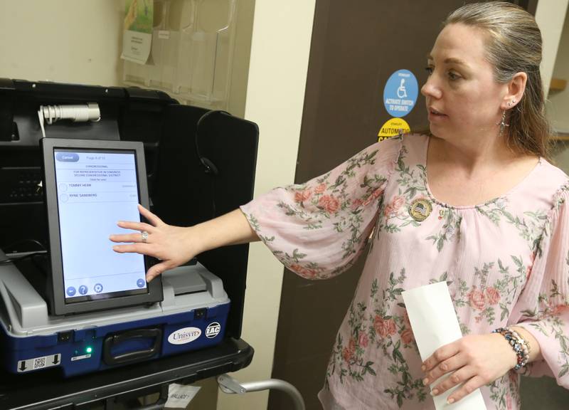 La Salle County Clerk Jennifer Ebner holds a sample printout of a electronic ballot during a demonstration of new voting machines Monday, Feb. 5, 2024, at the La Salle County Government Complex in Ottawa. La Salle County residents still can vote using fill-in-the-oval paper ballots, but the county now offers voters the choice of using ADA-compliant touchscreens.