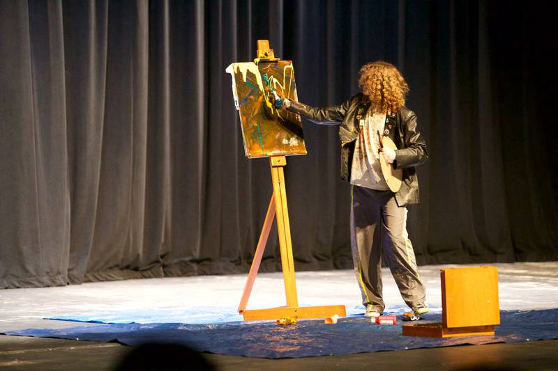 Mr. Kaneland contestant Adam Walker paints a picture  during Mr. Kaneland contest on Friday, March 15, 2024 at Kaneland High School in Maple Park. 
ALT TEXT