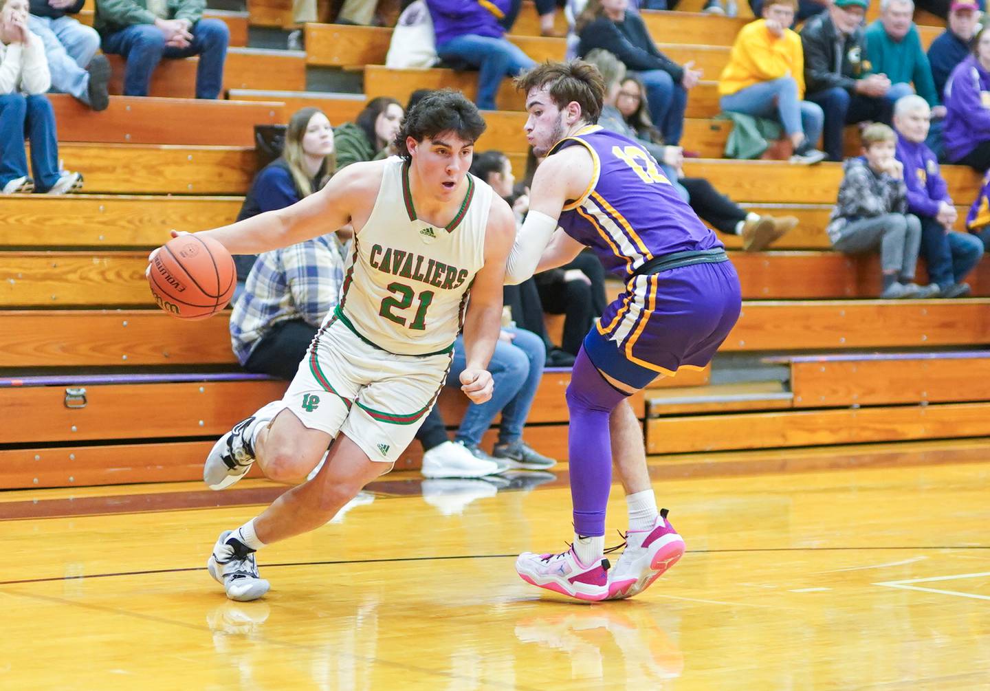 LaSalle-Peru's Josh Senica (21) drives the baseline against Mendota’s Braiden Freeman (12) during a first round game in the 60th annual Plano Christmas Basketball Tournament at Plano High School on Wednesday, Dec 27, 2023.