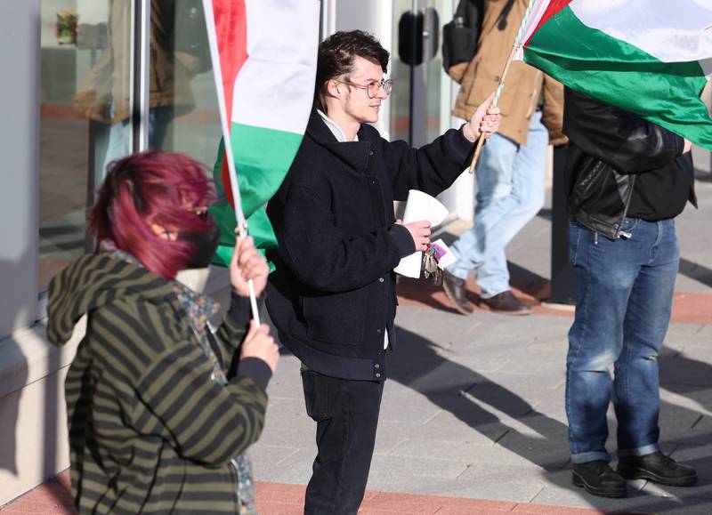 Demonstrators hold Palestinian flags during a protest against the Israel–Hamas war Thursday, Feb. 29, 2024, outside the Holmes Student Center at Northern Illinois University in DeKalb.
