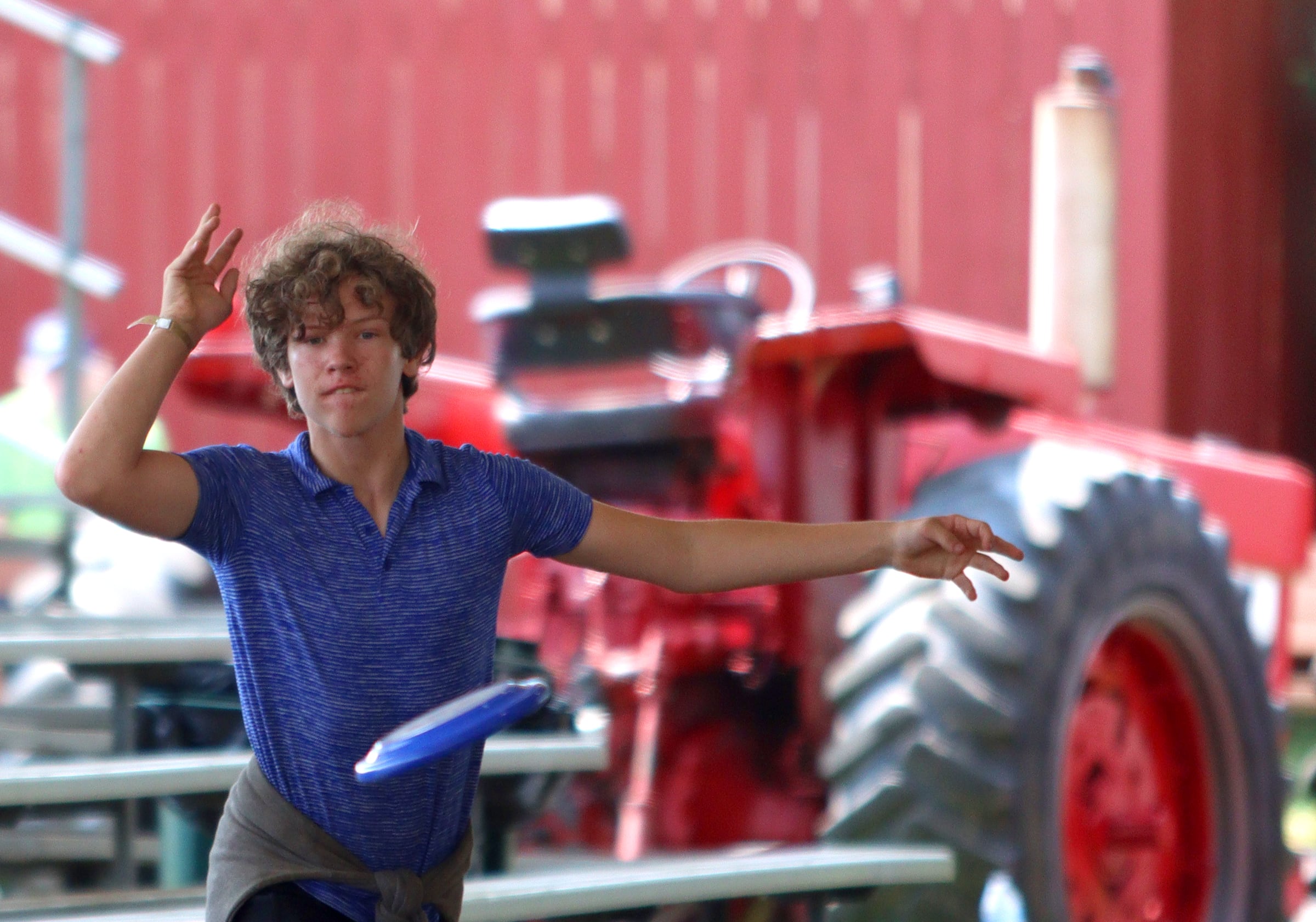 Josh Douglas, 15, of Woodstock plays frisbee with friends at the McHenry County Fair in Woodstock on Tuesday, July 30, 2024. Douglas is involved in showing goats and rabbits at the fair, and also has entries in 4H photography and leadership categories.