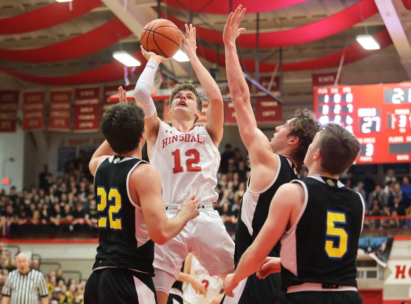 Hinsdale Central's Ben Oosterbaan (12) puts up a shot in traffic during the boys 4A varsity sectional semi-final game between Hinsdale Central and Lyons Township high schools in Hinsdale on Wednesday, March 1, 2023.