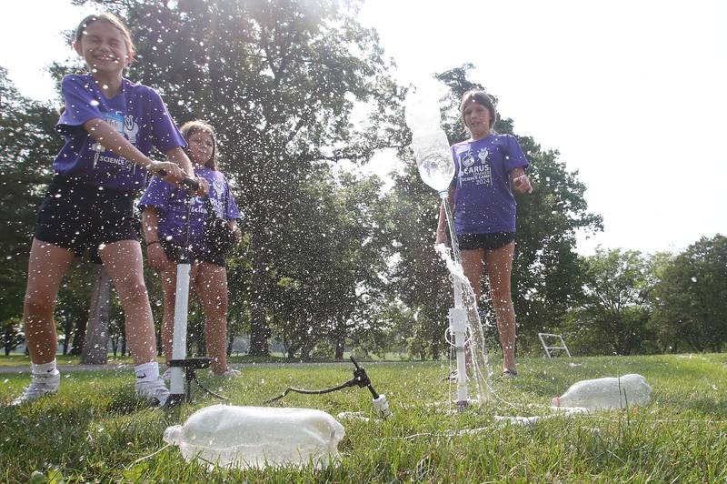 Mae Meyer and Adela Turigilatti launch a two liter rocket bottle during the 22na annual Carus Summer Science Camp on Friday, July 12, 2024 at St. Bede Academy.