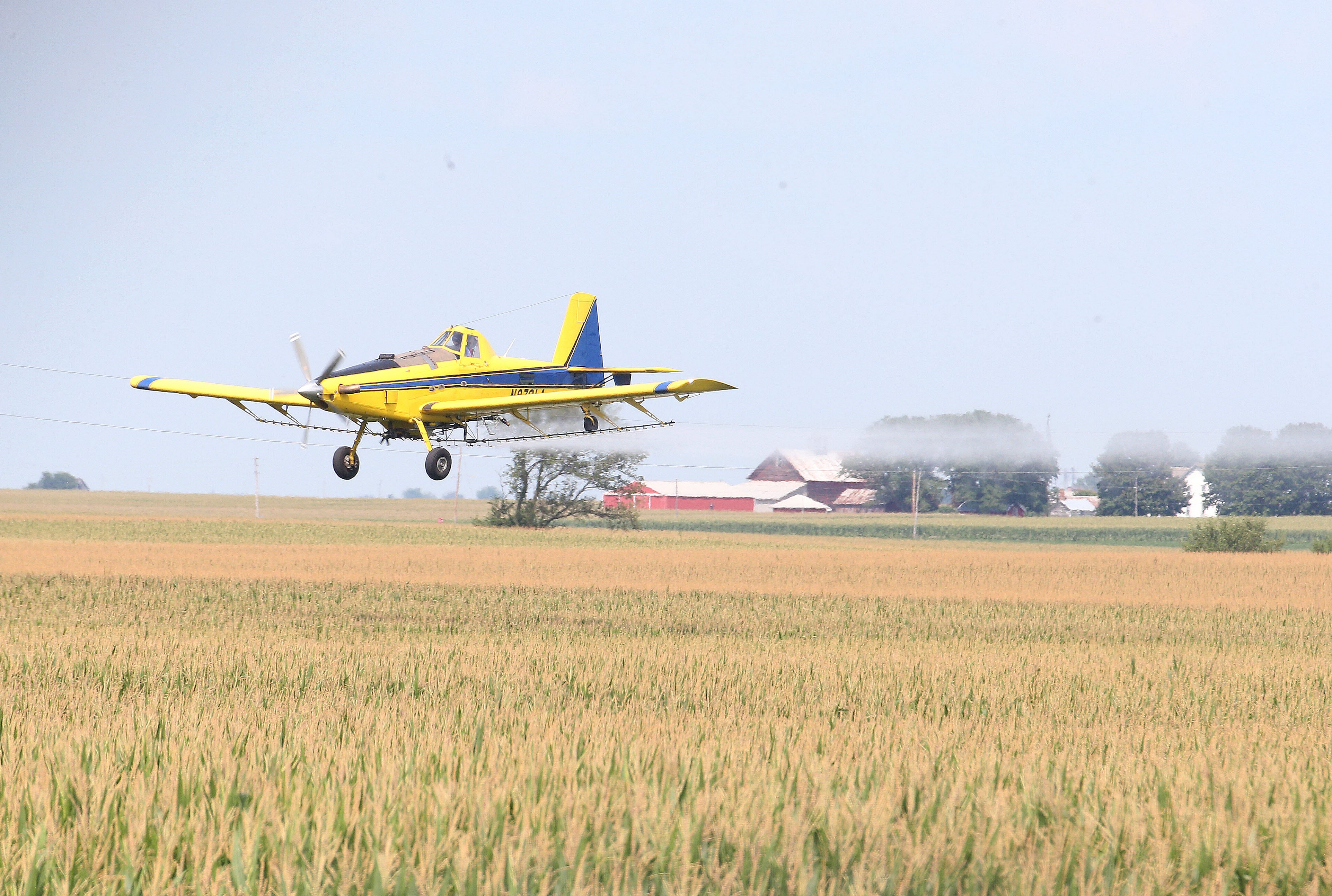 Agricultural aircraft makes its way over fields in La Salle County