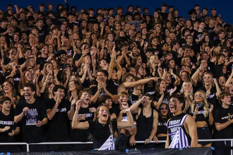 The Downers Grove North student section cheers on the team during a football game between Glenbard West at Downers Grove North on Friday, Sept 13th, 2024  in Downers Grove.