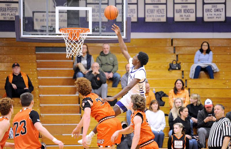 Plano's Christ Keleba goes up high against the Sandwich defense for a basket during a varsity basketball game at Plano High School on Tuesday, Dec. 5, 2023.