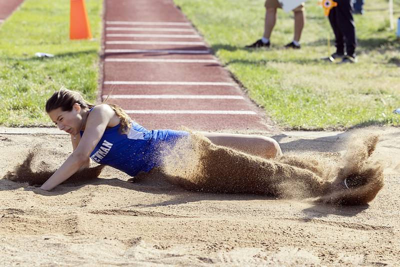 Newman’s Brooke Sanchez lands her triple jump attempt Wednesday, May 10, 2023 at the class 1A Erie girls track sectional.