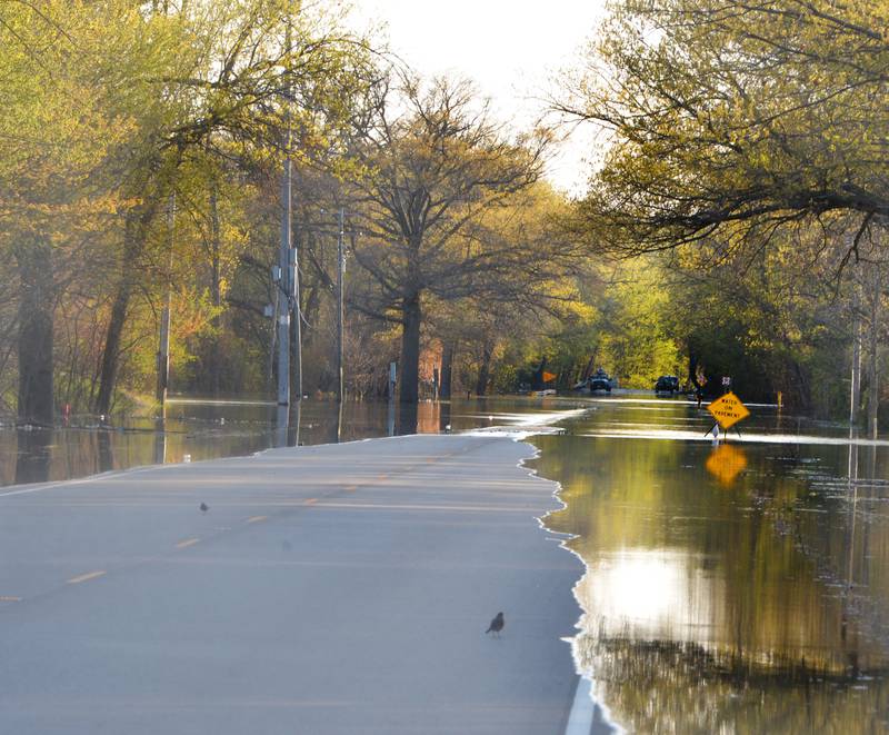 Water creeps across a section of Route 84 between Fulton and Albany on Thursday forcing traffic to be detoured around the flooded area.  The road was closed between Garden Plain Road and Albany Road, Park Ave N. In Albany.