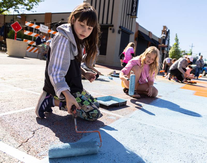 Scarlett Gorski, 8, paints the intersection of Riverside Avenue and Walnut Avenue in St. Charles at the Paint the Riverside event hosted by the St. Charles Arts Council on Saturday, May 11, 2024.