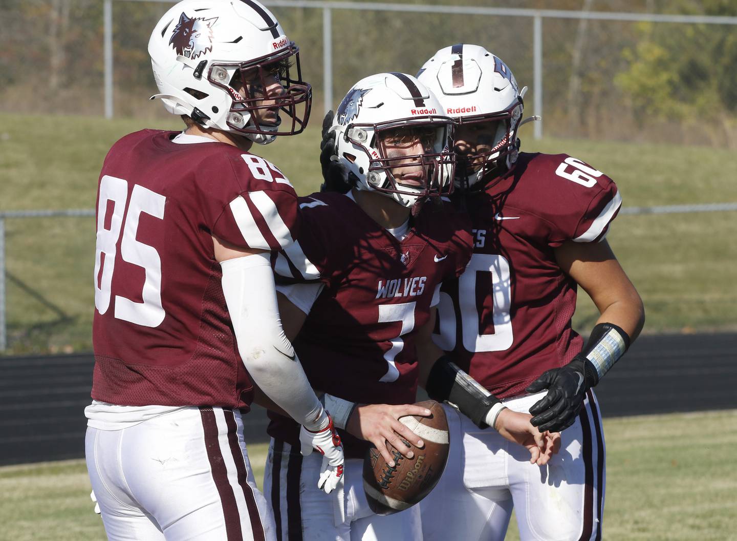 Prairie Ridge's Tyler Vasey, center celebrates a touchdown with teammates, Landon Miller, left, and Fernando Rodriguez, right, during a IHSA Class 6A first round playoff football game Saturday, Oct. 29, 2022, between Prairie Ridge and Crystal Lake South at Prairie Ridge High School in Crystal Lake.