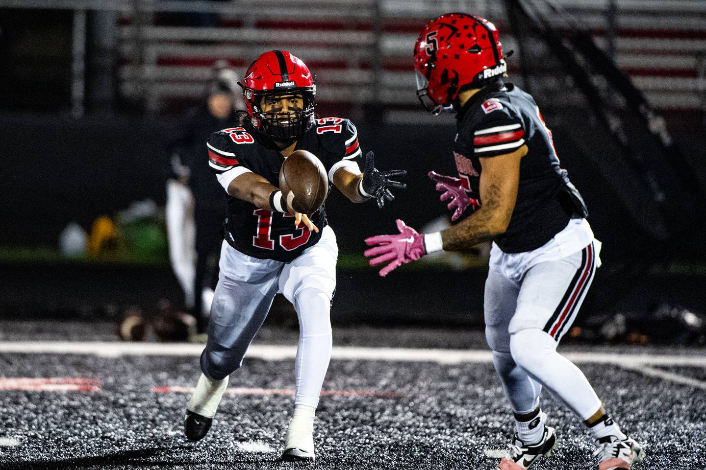 Bolingbrook's Jonas Williams tosses the ball to Darnell Stephens during a game against Lockport on Friday Oct. 13, 2023 at Bolingbrook High School
