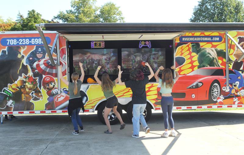 A group of friends dance as they watch the action station for "Just Dance" on a Rolling Video Games Chicago game truck during the Fall Festival at Grant Township Center on October 1st in 
Ingleside. The event was sponsored by the Village of Fox Lake and Grant Township.
Photo by Candace H. Johnson for Shaw Local News Network