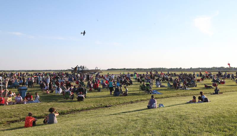 A gigantic crowd watches airplanes fly over during the annual TBM Avenger Reunion and Air Show on Friday, May 17, 2024 at the Illinois Valley Regional Airport in Peru.