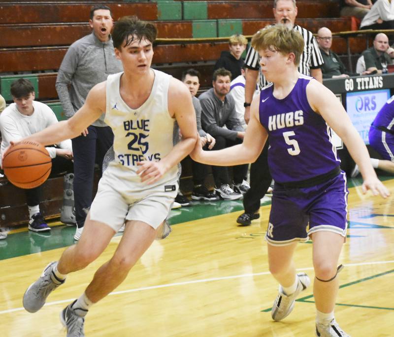 Woodstock’s Trent Butler drives at Rochelle’s Carson Lewis during Wednesday’s IHSA 3A regional semifinal at Rockford Boylan.