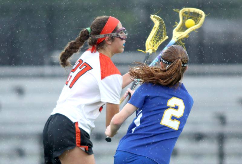 Crystal Lake Central’s Anna Starr, left, moves the ball against Lake Forest’s Megan Rocklein during girls lacrosse supersectional action at Metcalf Field on the campus of Crystal Lake Central Tuesday.