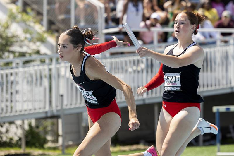 Huntley’s Saenz K’Leigh reaches for the baton from Emily Byers in the 3A 4x200 Saturday, May 18, 2024 at the IHSA girls state track meet in Charleston.
