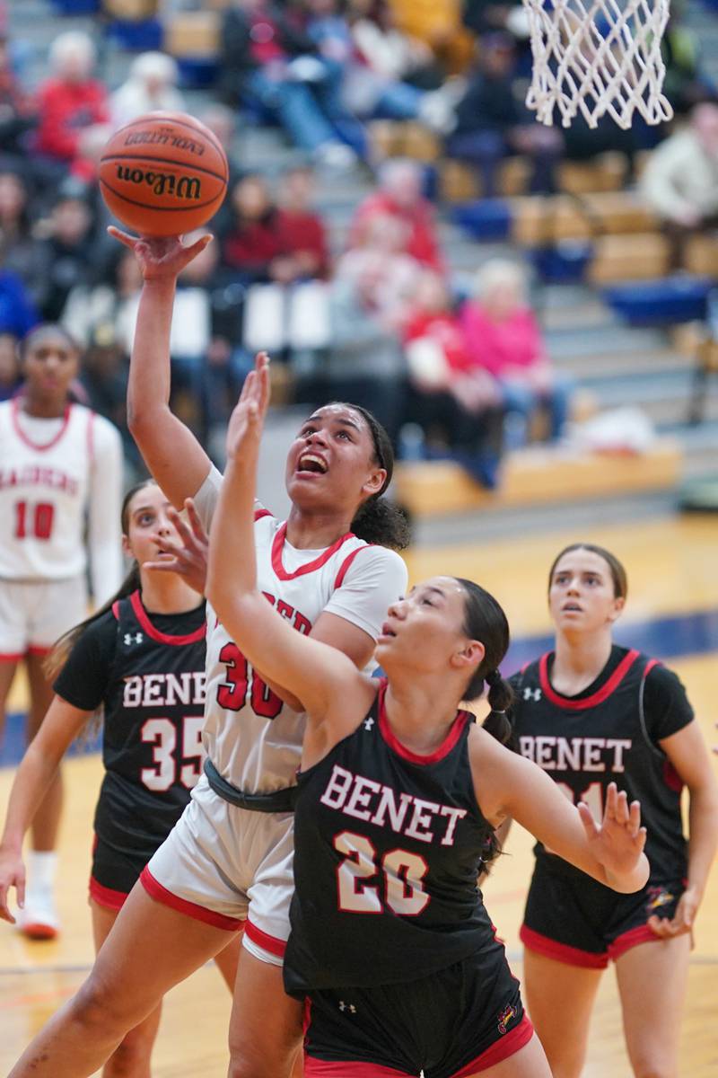 Bolingbrook's Angelina Smith (30) shoots the ball in the post over Benet’s Emma Briggs (20) during a Oswego semifinal sectional 4A basketball game at Oswego High School on Tuesday, Feb 20, 2024.