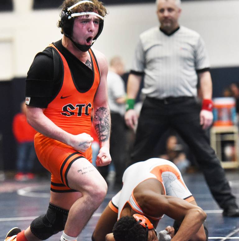 St. Charles East’s Jayden Colon, top, celebrates his win over DeKalb’s Mekhi Cave in the 144-pound final during the Class 3A Conant wrestling sectional on Saturday, Feb. 10, 2024 in Hoffman Estates.