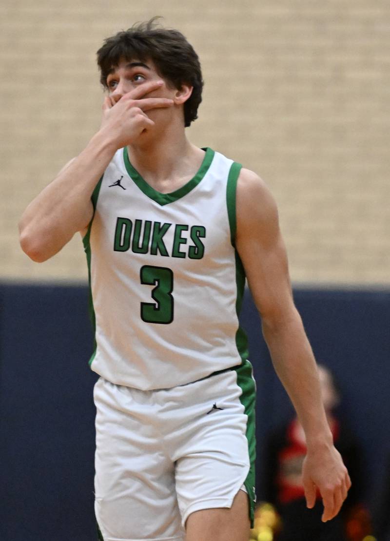 York’s A.J. Levine gestures after hitting a shot while being closely guarded by a Batavia defender during the Addison Trail Class 4A boys basketball sectional semifinal on Wednesday, Feb. 28, 2024 in Addison.