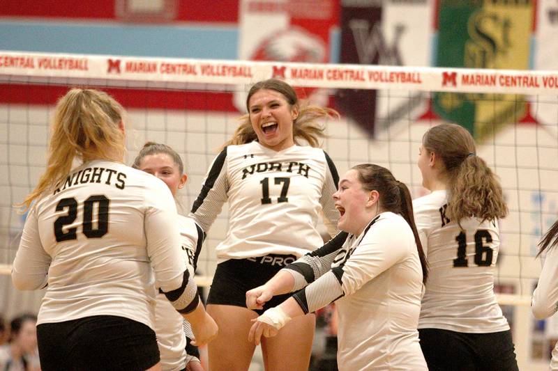 Grayslake North’s Maddie Von Allmen (17) and the Knights celebrate a two-set win over Marian Central in girls volleyball in Woodstock Monday.