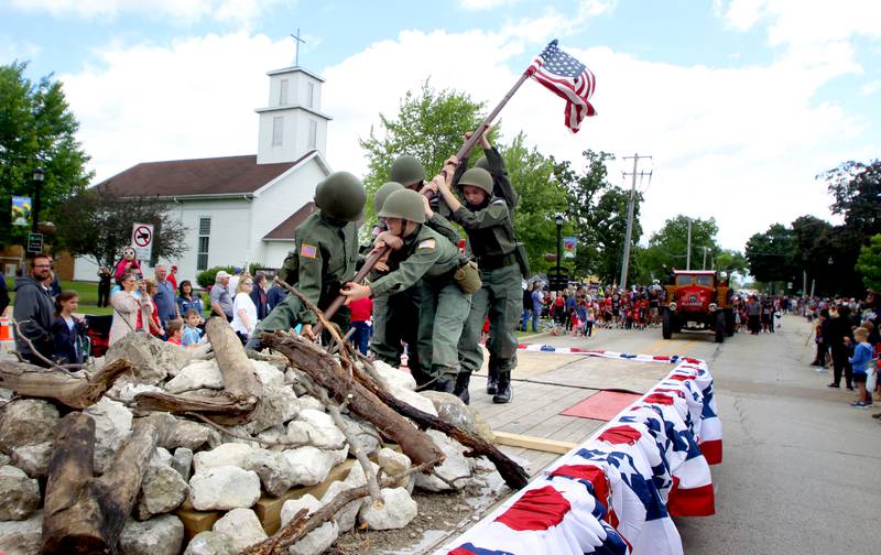 Members of the Ruth family re-enact the famous 1945 Joe Rosenthal image of the raising of the Flag at Iwo Jima as part of the Huntley Memorial Day parade and observance Monday.